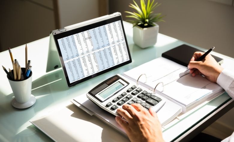 Graphic showing a person calculating severance pay for their employees.