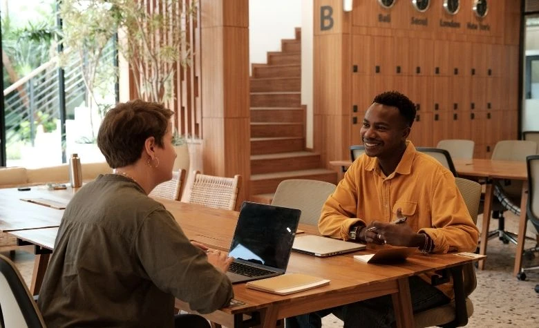 two people discussing HR outsourcing costs 