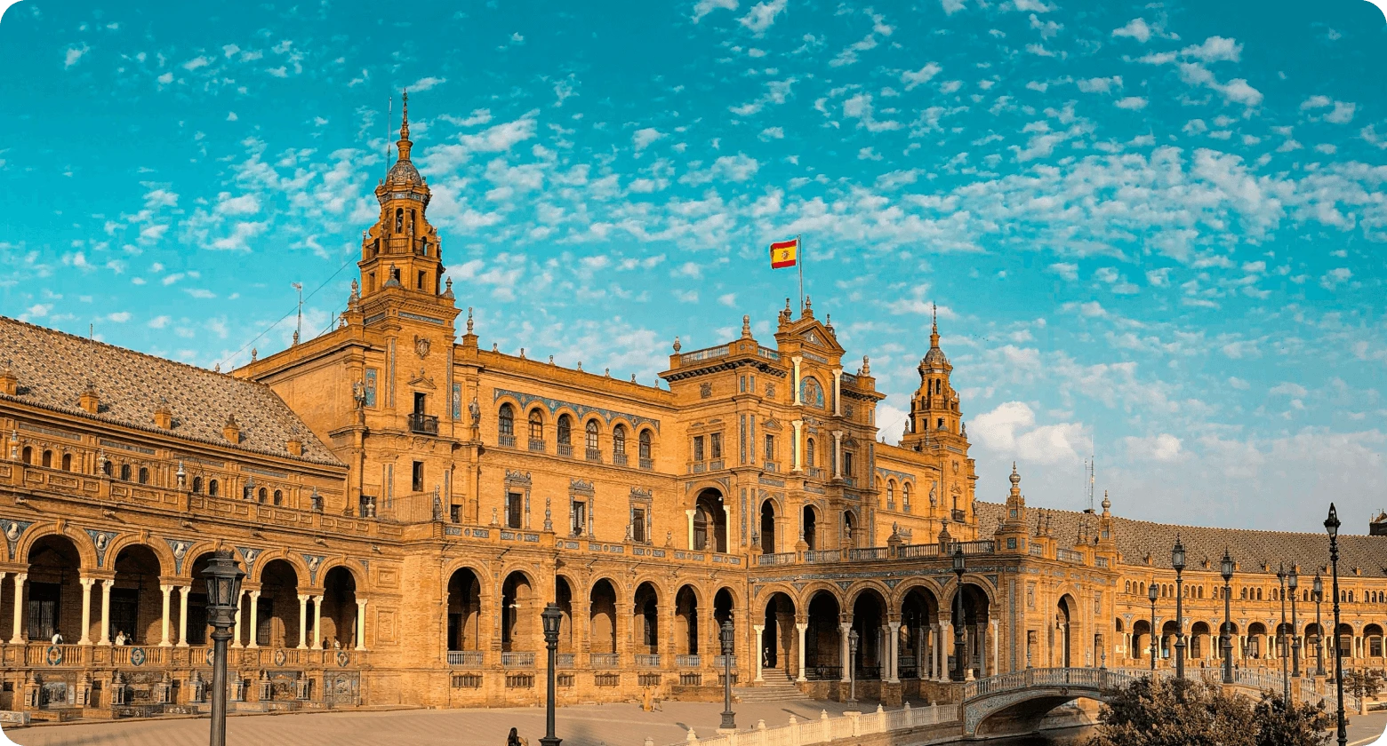 View of Seville's Plaza de España with the Spanish flag, symbolizing digital nomad life in Spain.