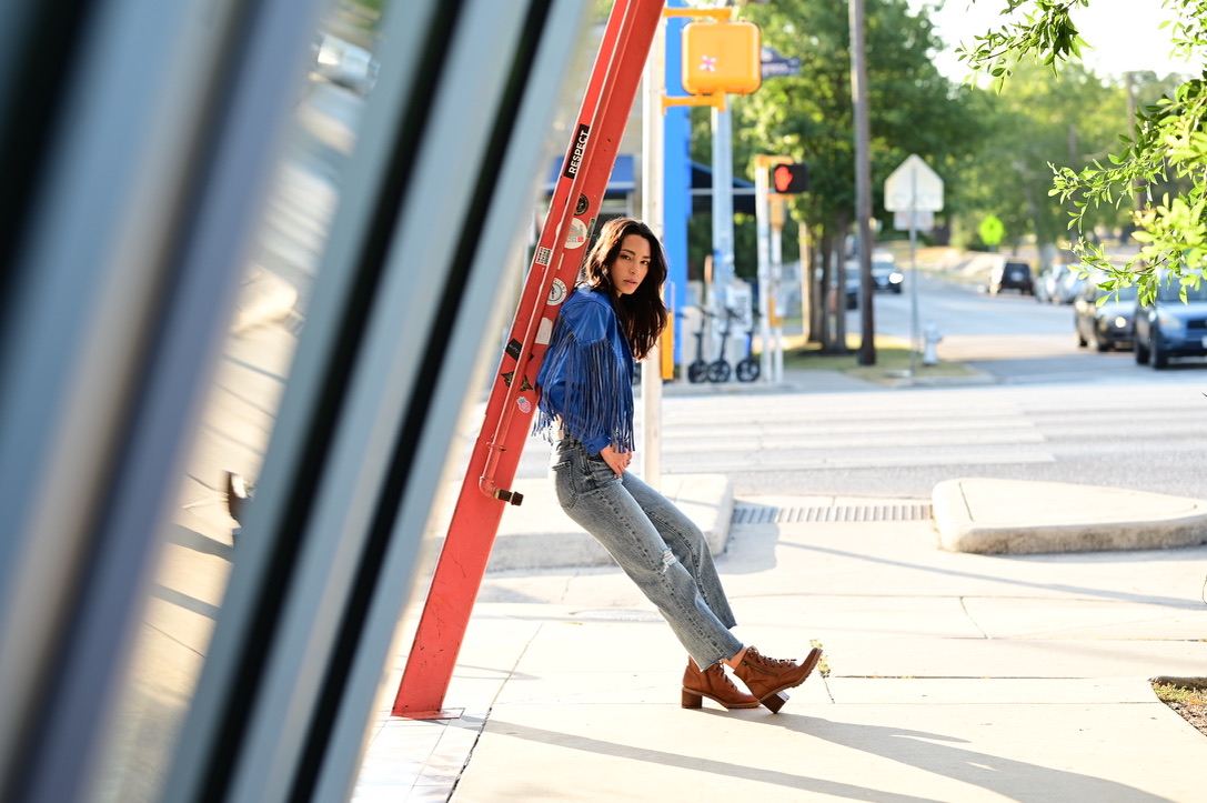 A woman leaning against a ladder