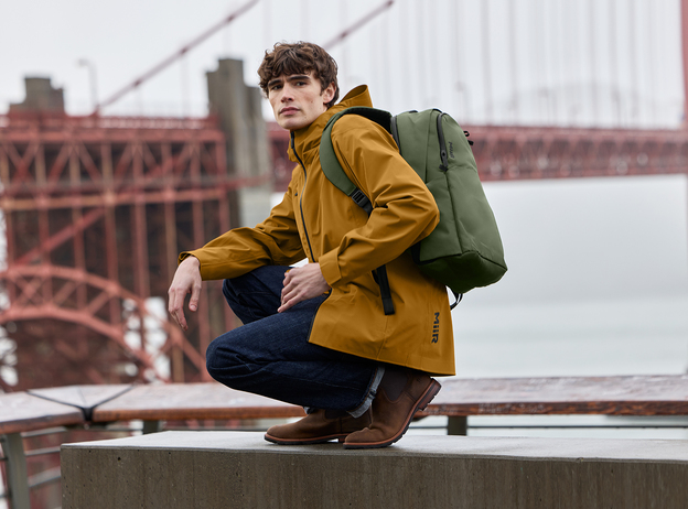 A man sitting in front of the Golden Gate Bridge