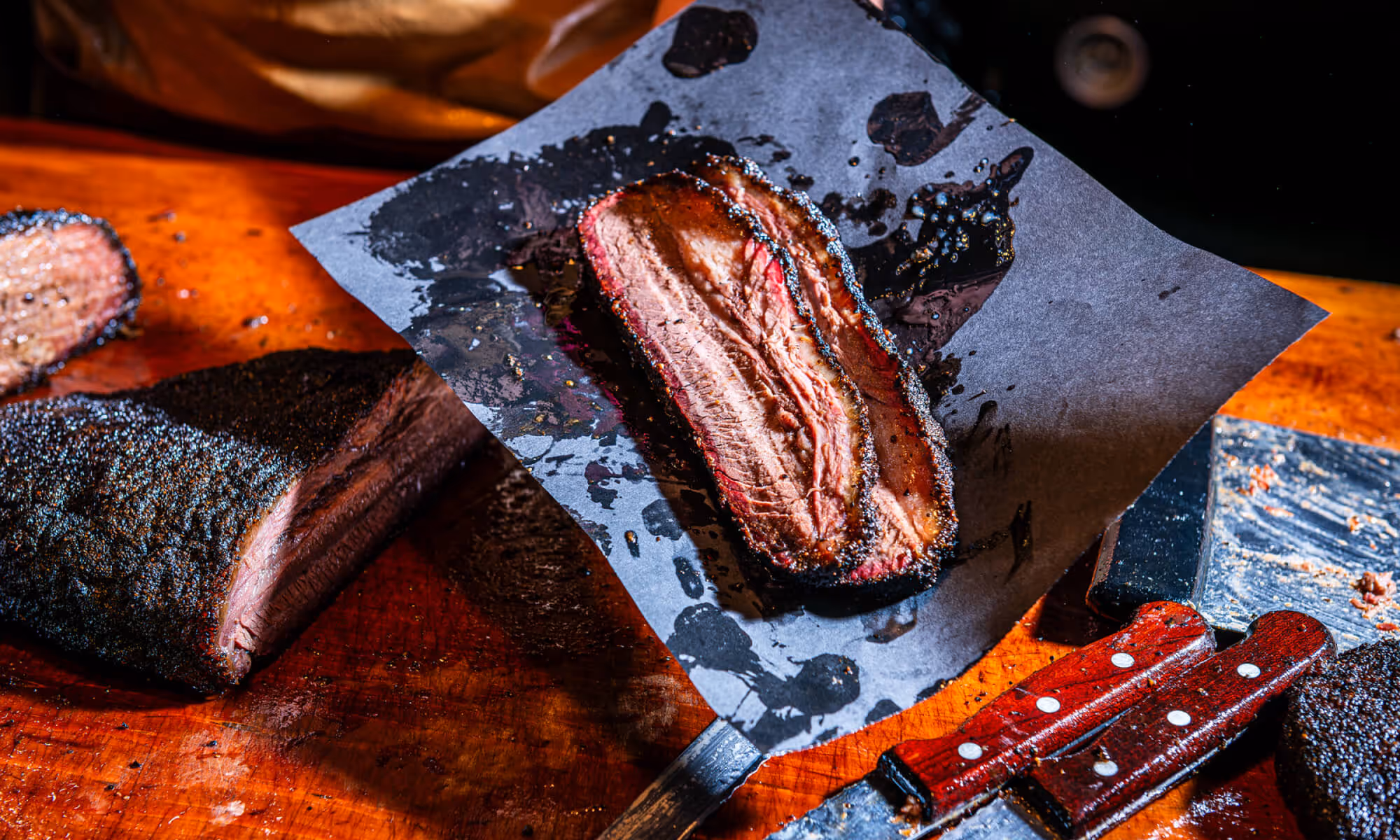 Sliced juicy brisket on butcher paper and cutting board at 2Fifty BBQ in Washington D.C. by Sophie Mac Photo.