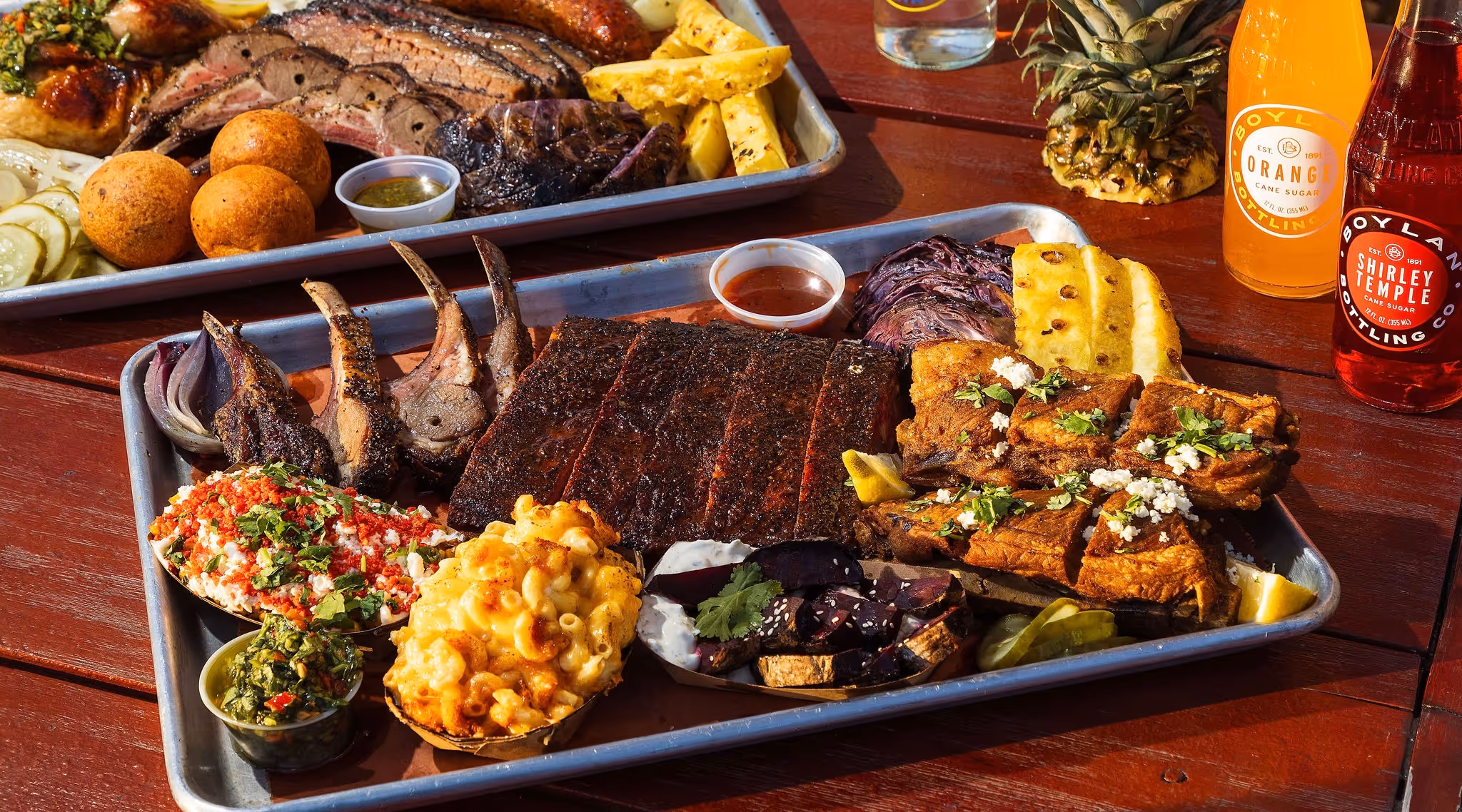 A BBQ feast with ribs, lamb chops, sides, grilled pineapple, and sodas at 2Fifty BBQ in Washington D.C. by Sophie Mac Photo.