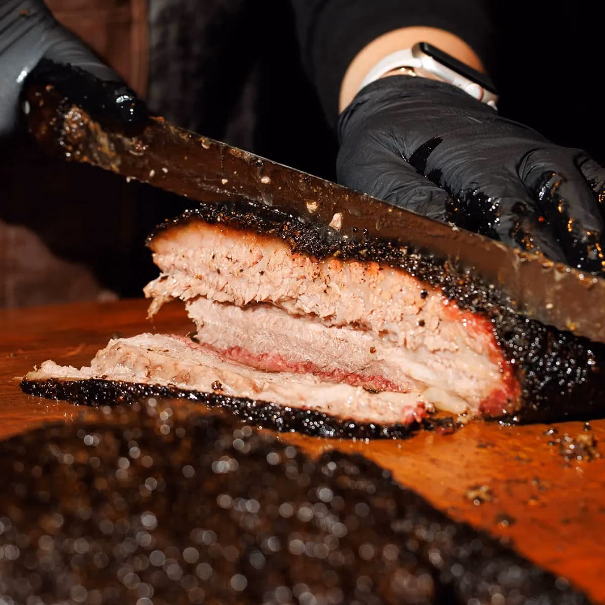 American Wagyu brisket being sliced at 2Fifty BBQ, Texas-style wood-smoked barbecue