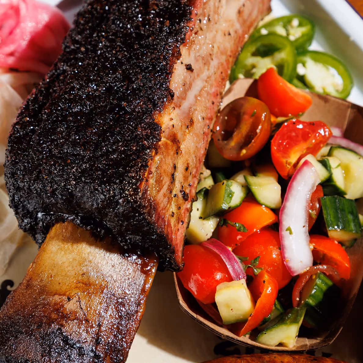 Beef ribs with tomato cucumber salad at 2Fifty BBQ, Texas-style wood-smoked barbecue