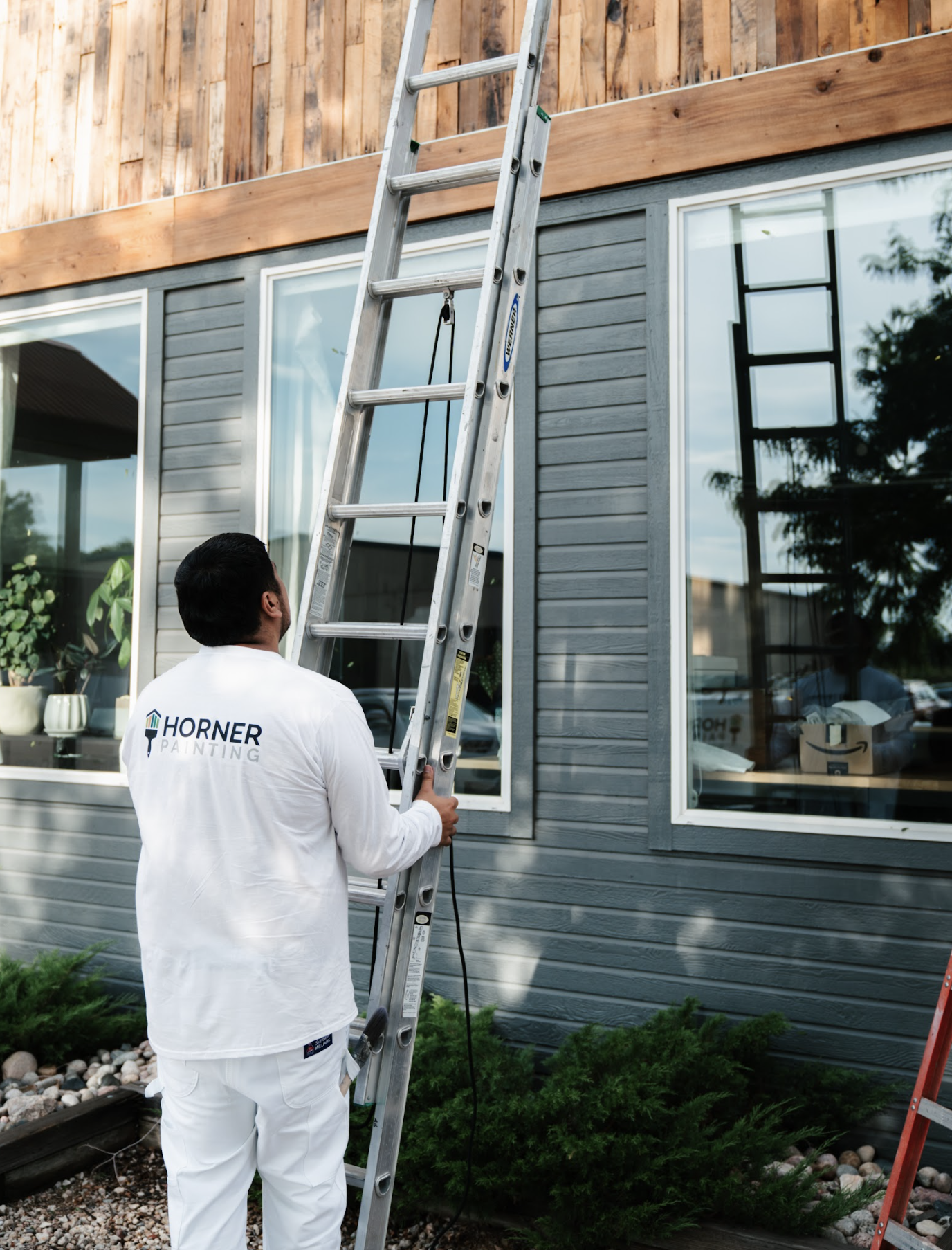 Man holding a ladder With house in the back