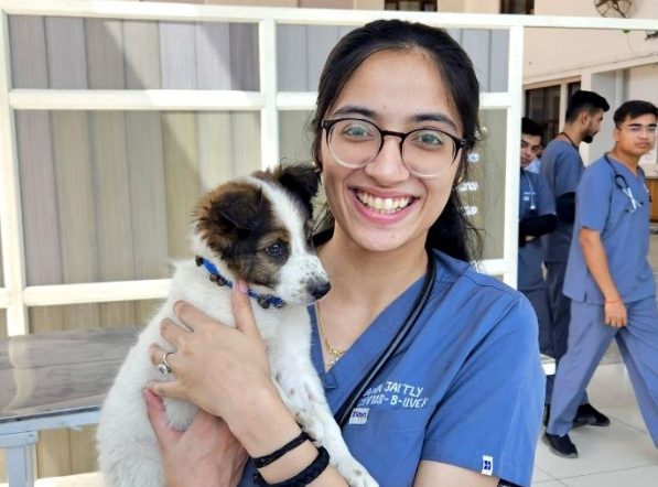 vet student with a puppy