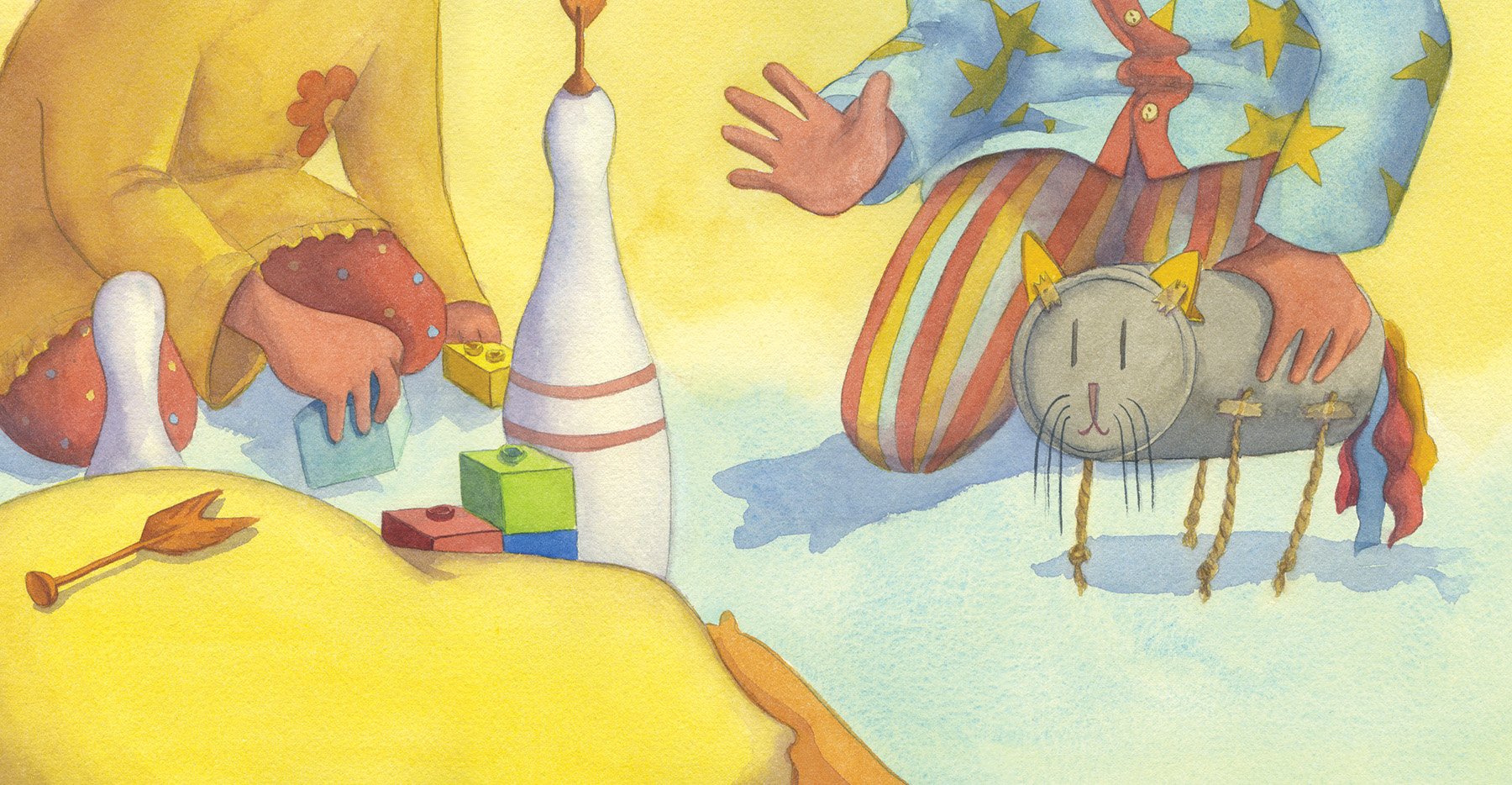 Two children sitting on the floor playing with building blocks, bowling pins, and a toy cat made of a can with rope legs.