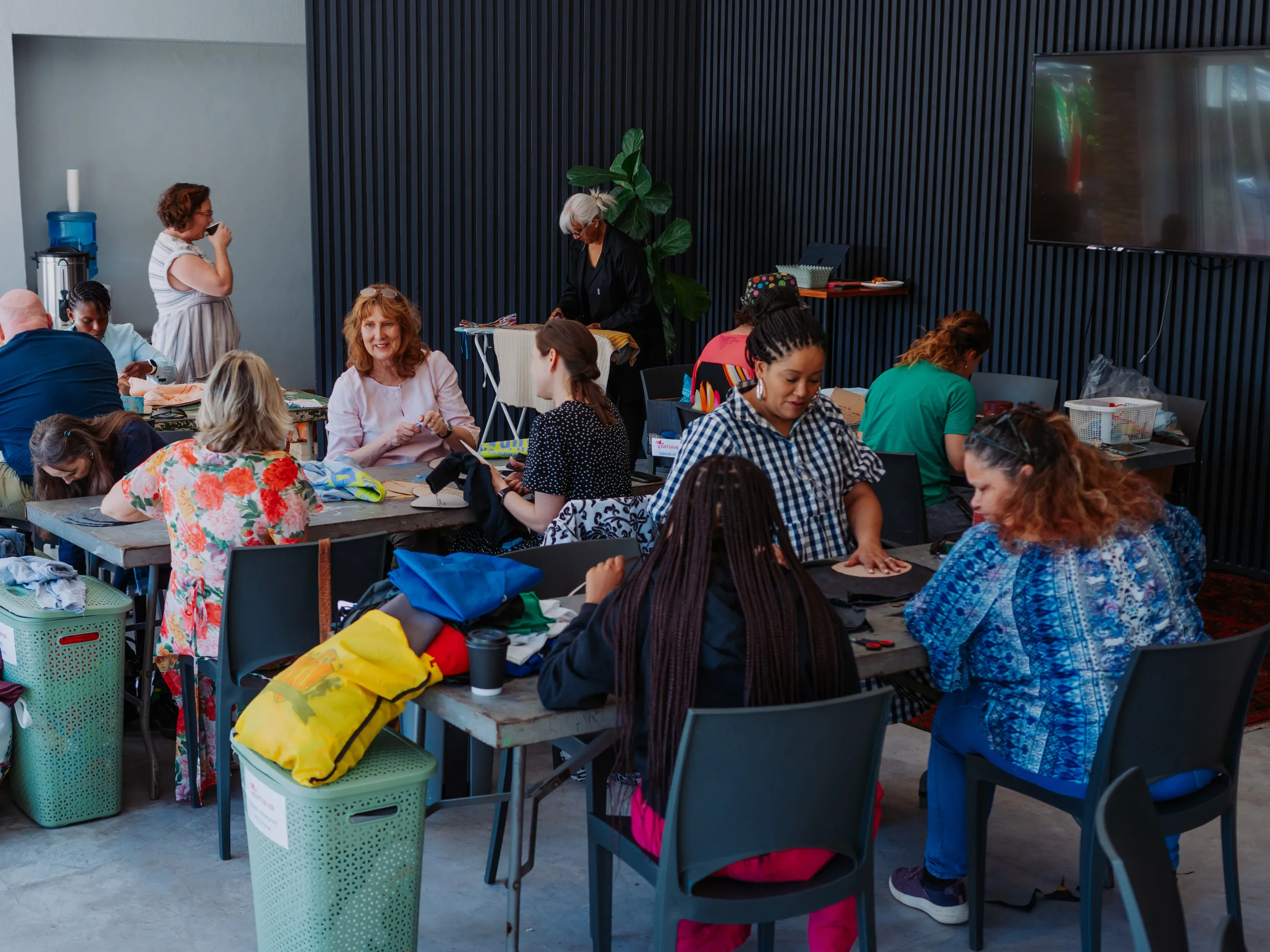 Group of volunteers sewing at an Love Our City sewing morning.