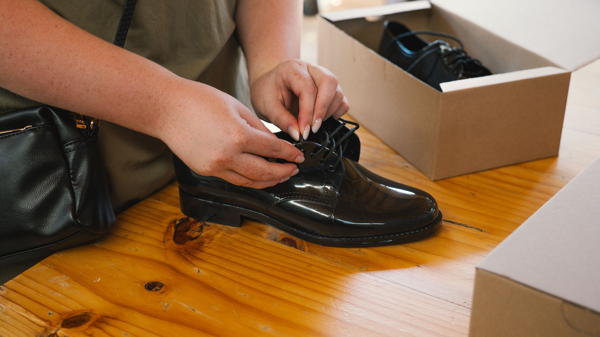 Volunteer packing school shoes into boxes for donation.