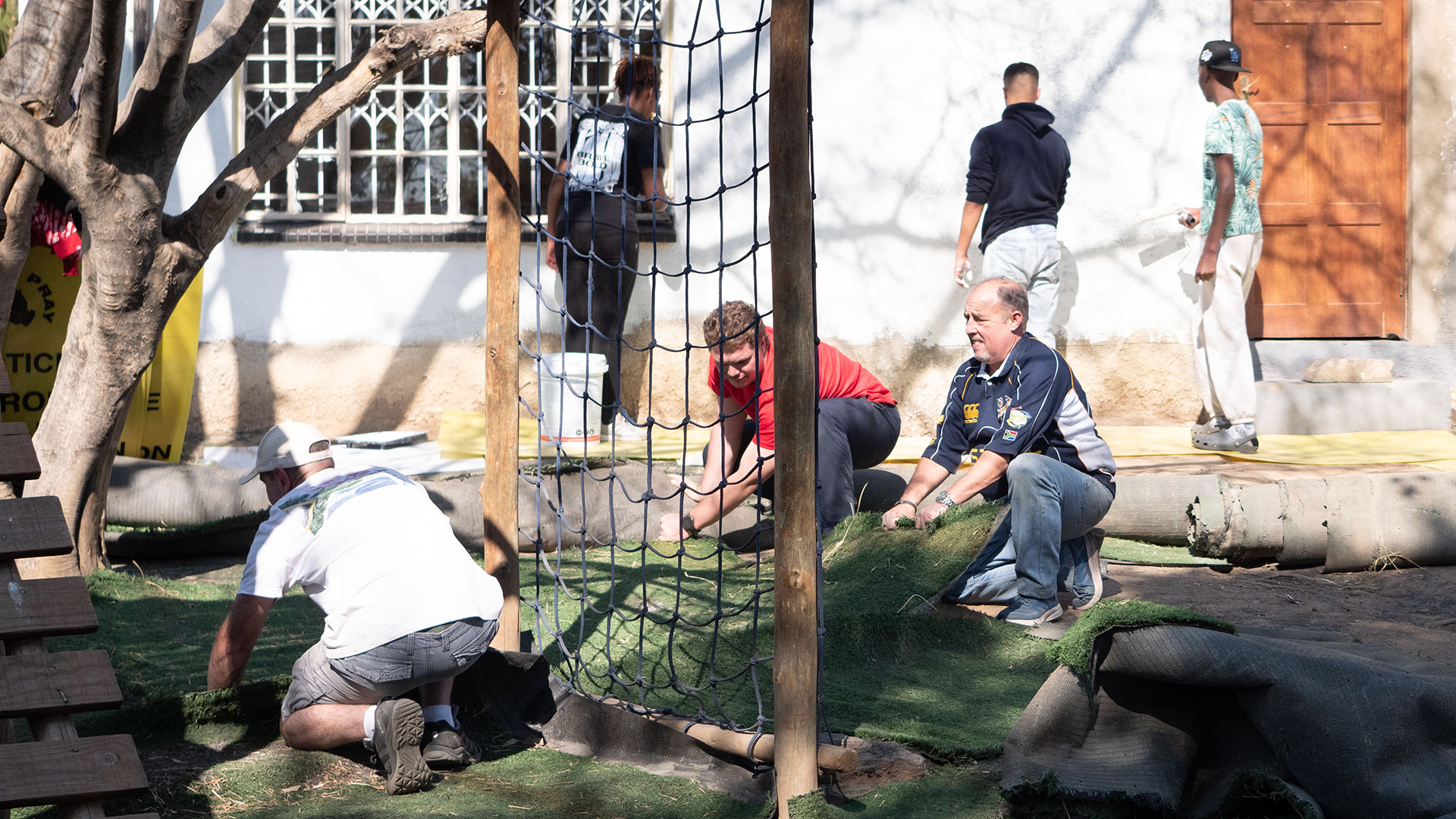 Group of volunteers at a school outreach building a playground.