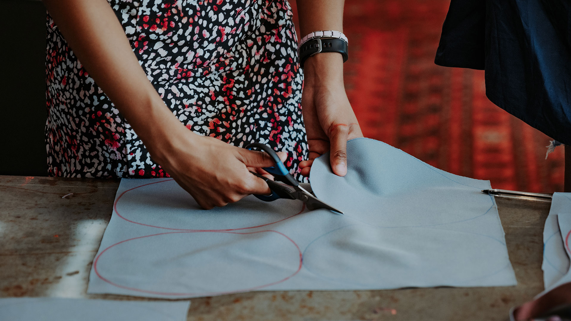 Volunteer cutting cloth.
