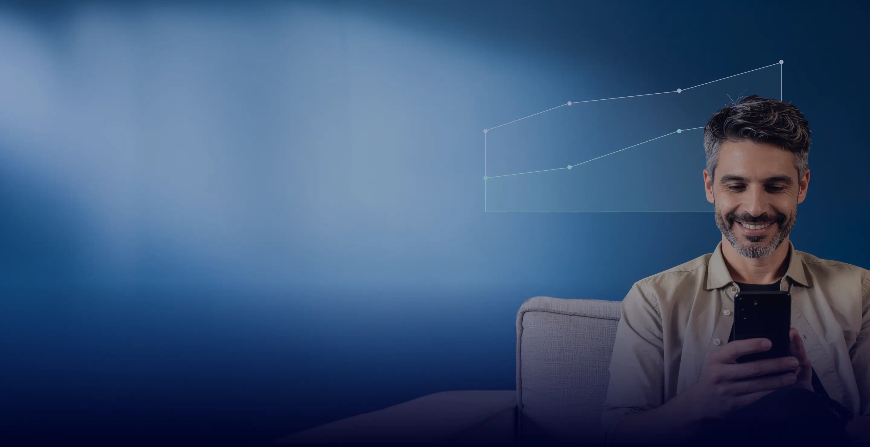 Smiling man sitting on a couch looking at his smartphone with digital upward trend graphs in the background.