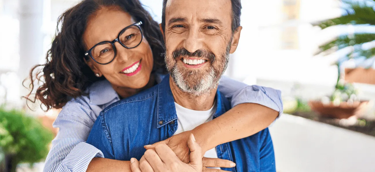 A happy, older couple smiles because they were able to get dental implants after successful bone grafting in Southern California