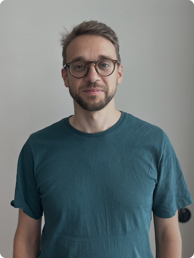 A man wearing glasses and a blue shirt.