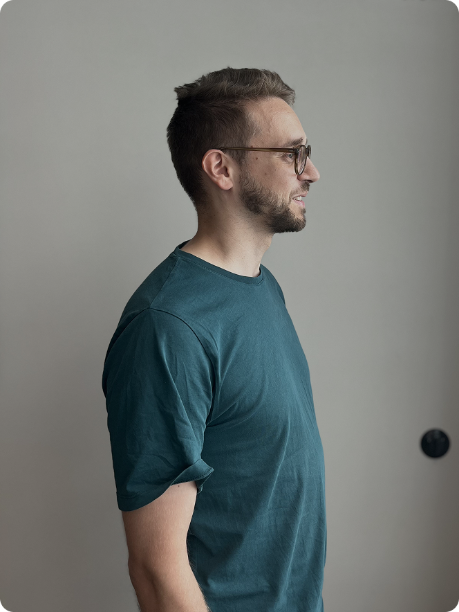 A man wearing a blue shirt and glasses.