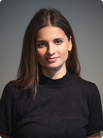A woman wearing a black shirt and smiling.