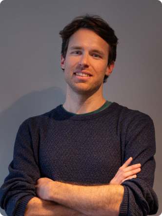 A man with a beard and a blue sweater.