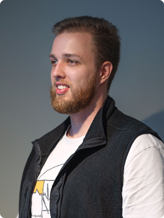 A man with a beard and a vest.
