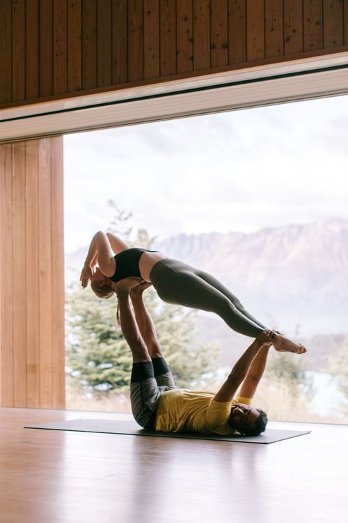 two people doing acro yoga