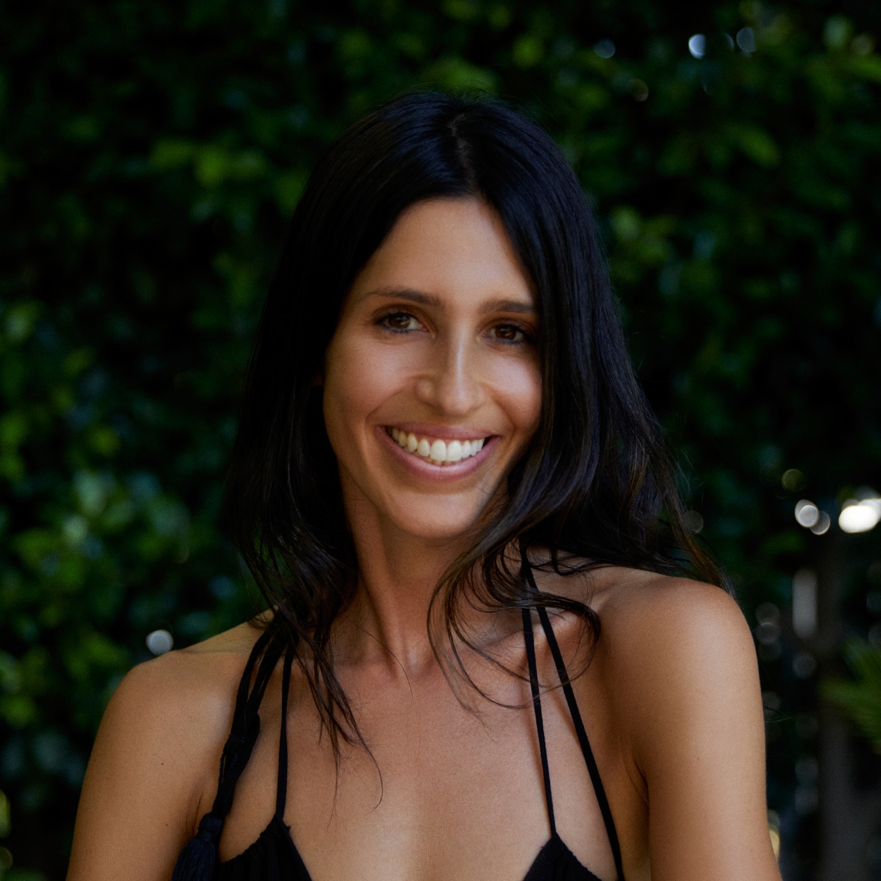 a woman's portrait on a natural plant background