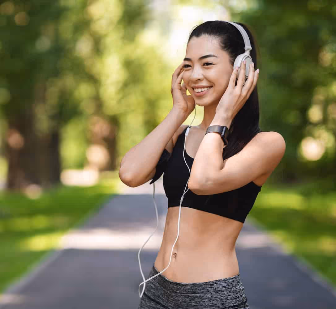 cheerful female athlete listening to everything lifestyle podcast