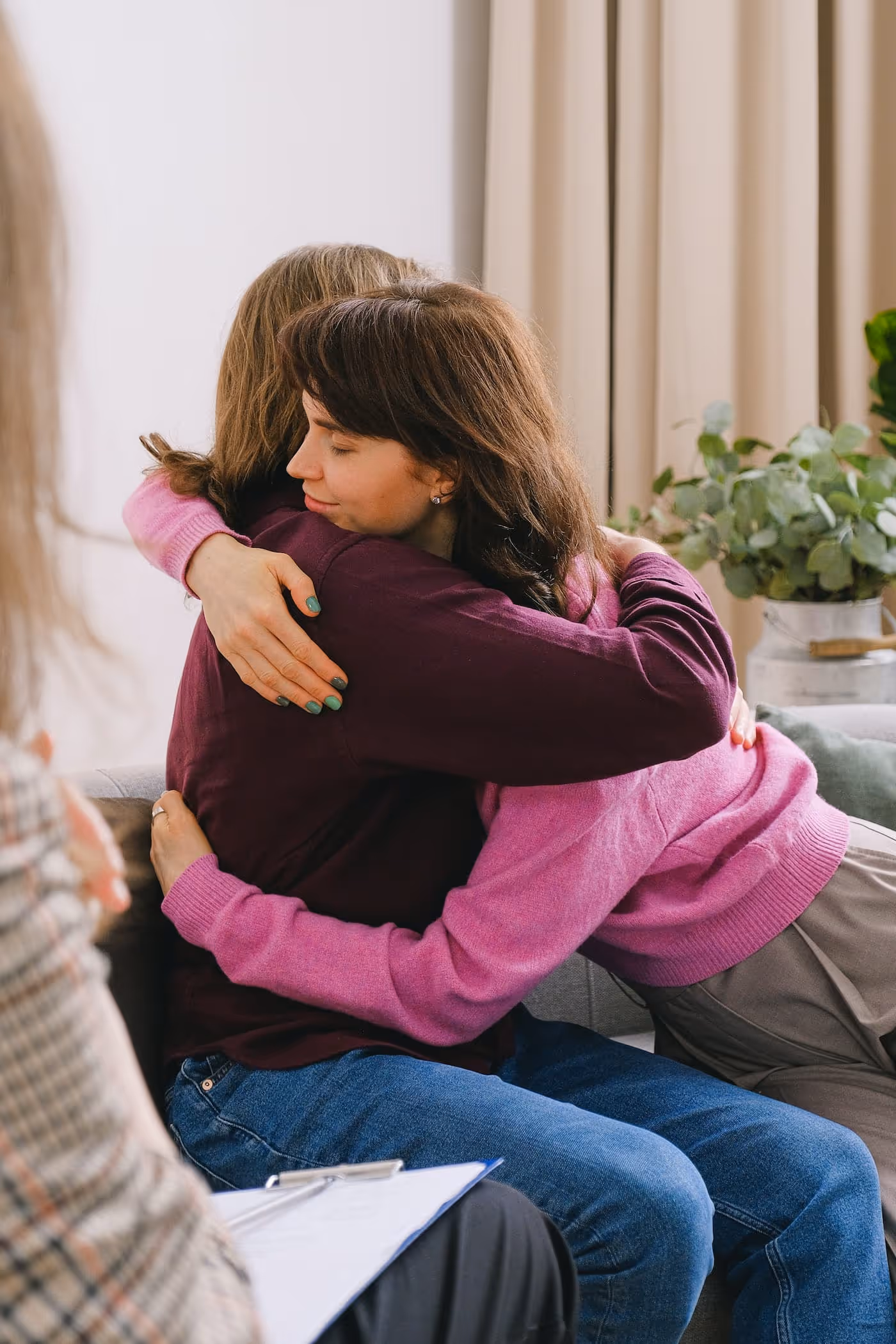 two women embracing and supporting each other