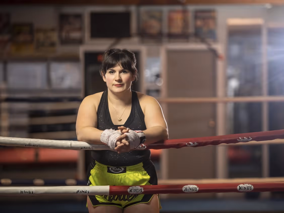 female boxer standing in the ring facing camera