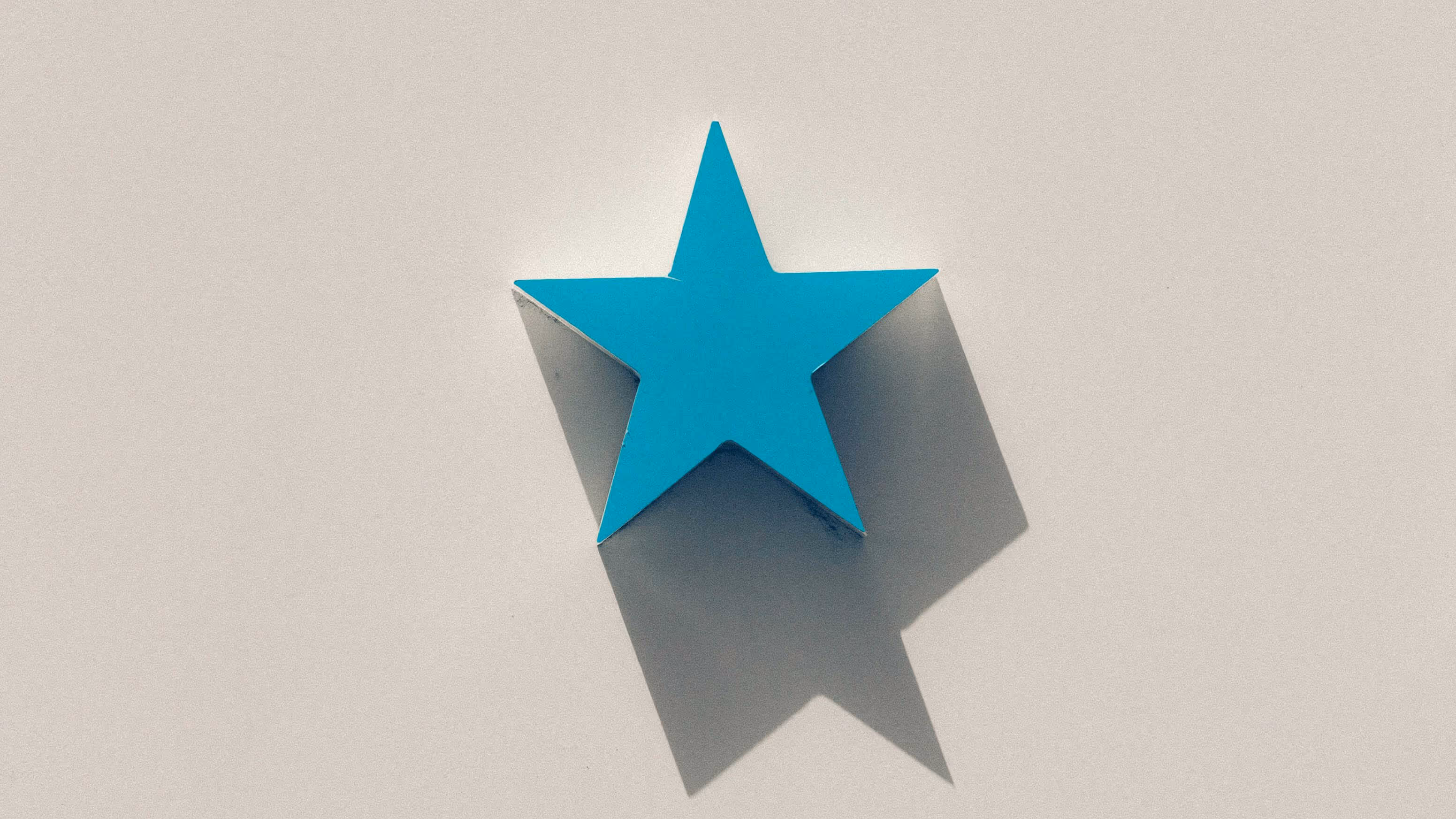 A single blue star displayed against a white backdrop.
