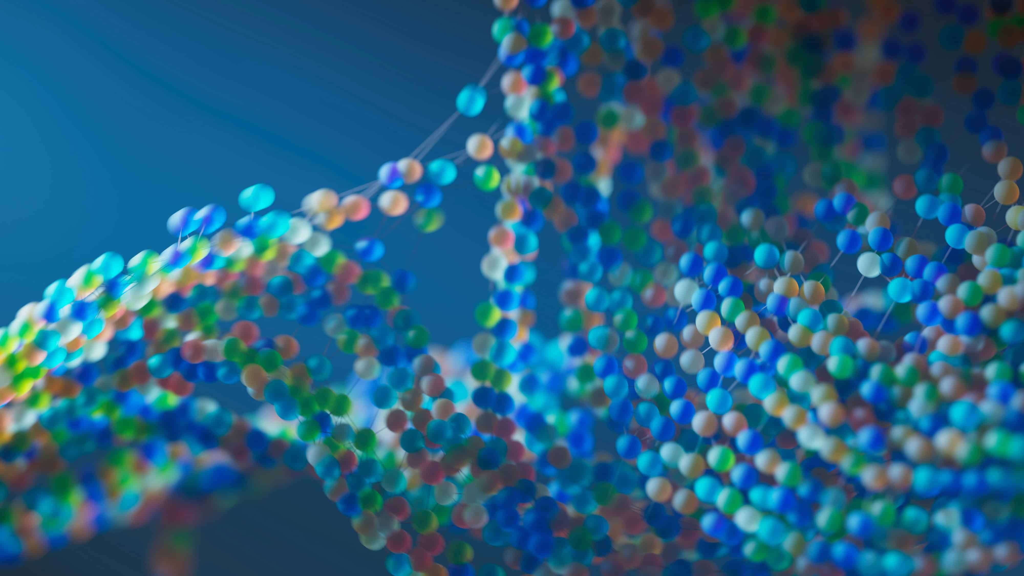 Abstract close-up of a colorful, blurred molecular structure with interconnected spheres in blue, green, and pastel tones against a soft blue background.