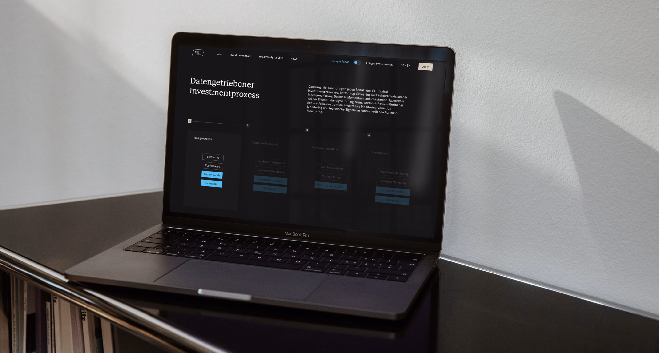 MacBook Pro on a desk with a screen showing a German data-driven investment process webpage.