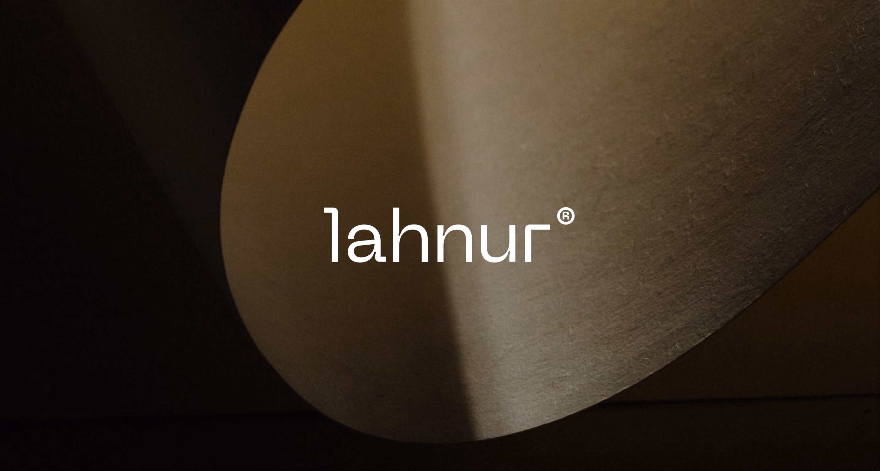 The word lahnur with a registered trademark symbol over a curved, softly lit surface.