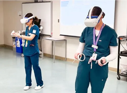 Two nurse learners wearing VR headsets in a classroom