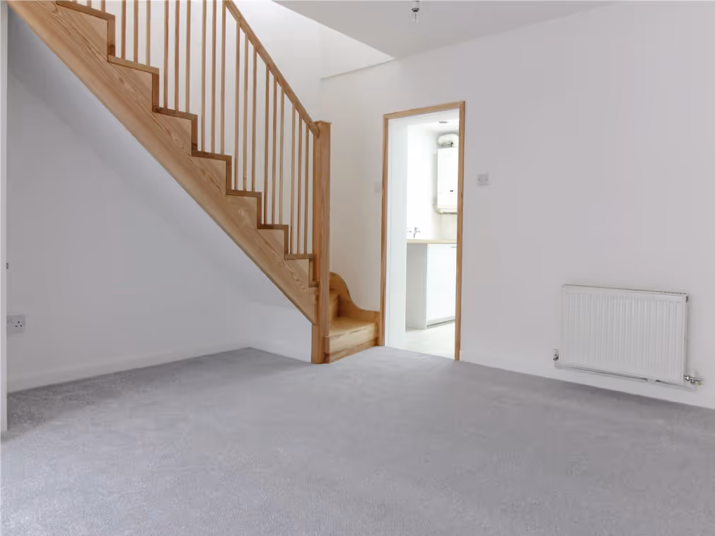 Room under renovation with reflective insulation panels labeled 'IKO enertherm' installed on the floor between wooden battens.