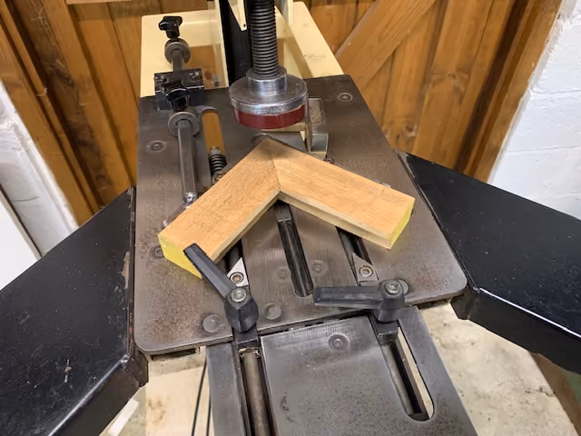 Mitred timber frame corner clamped on the underpinner before joining