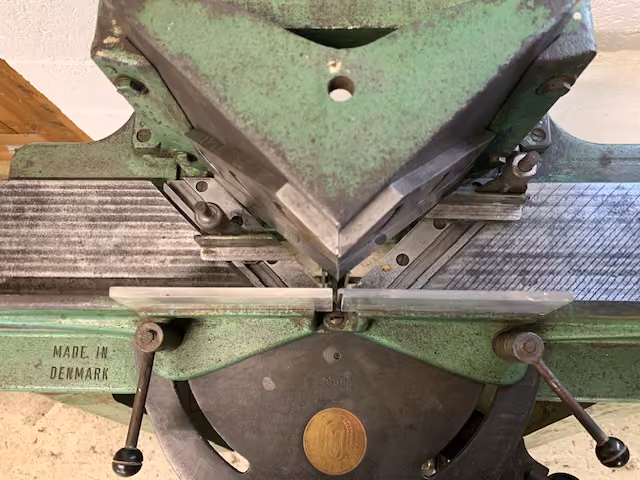 Blades of a Danish made mitre guillotine used to cut picture frame mouldings at 45 degrees