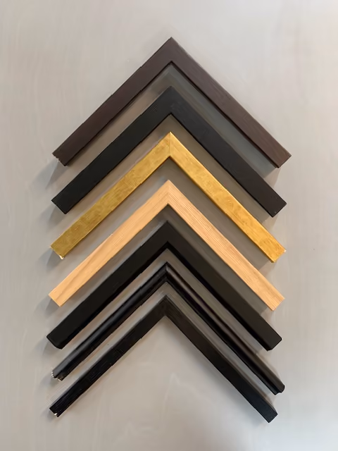Picture frame corner samples in black, dark brown, gold and natural timber