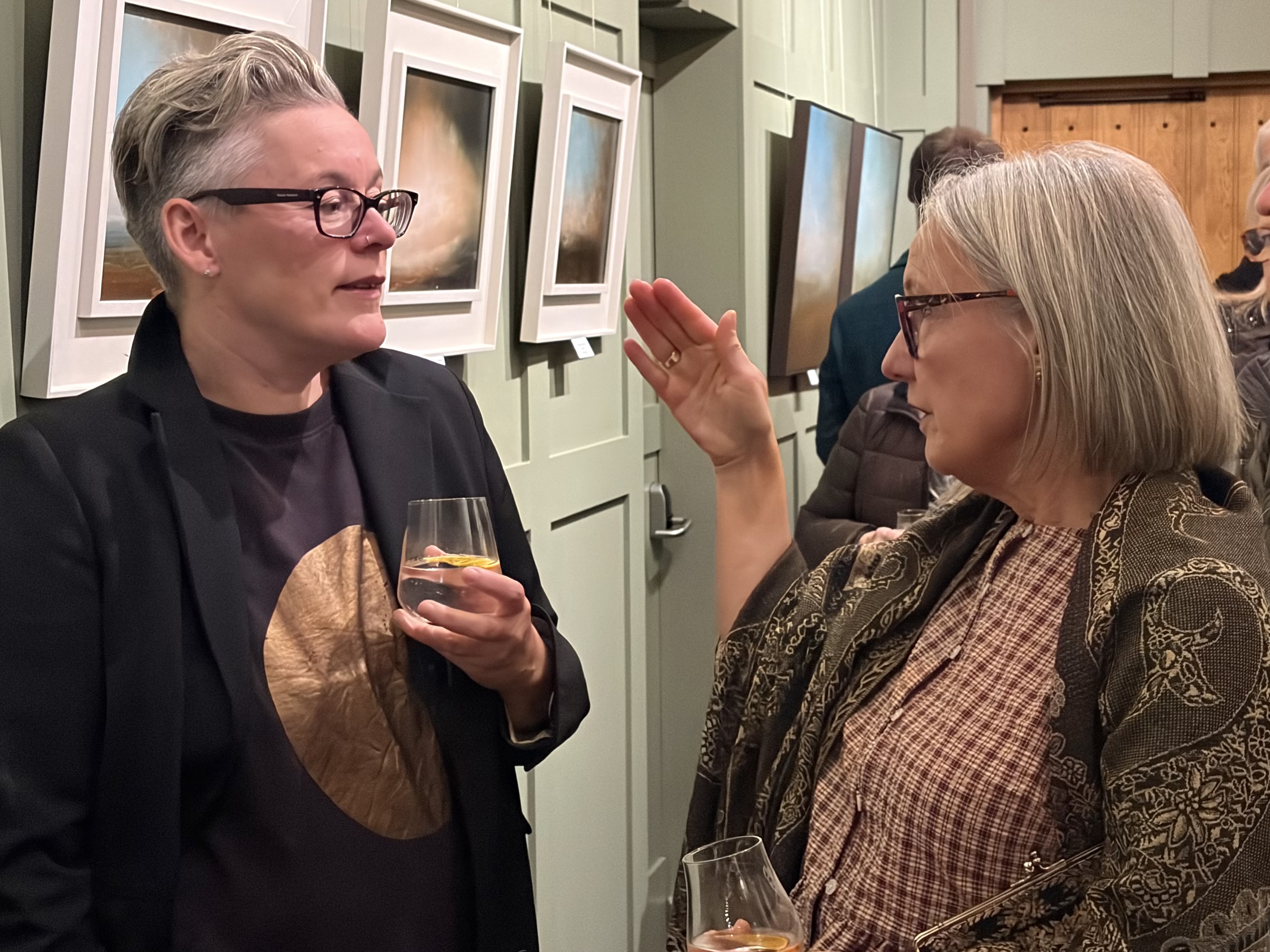 Paula Dunn discussing her art with Christine Daniel at The Biscuit Factory 's inaugural exhibition at Ad Gefrin, Wooler