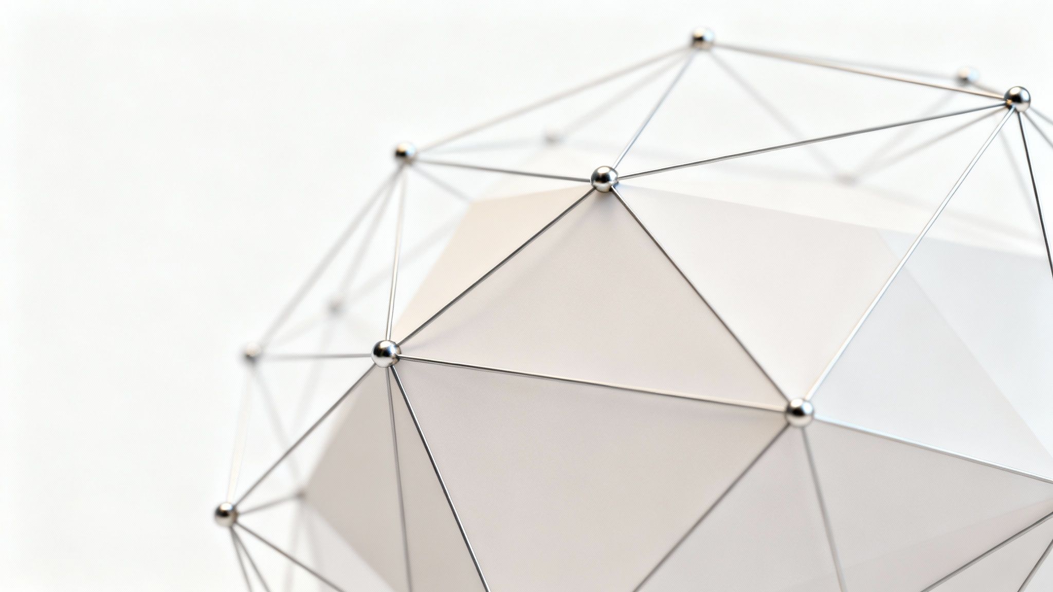 Close-up of a metallic geodesic sphere with a white, facetted interior against a light background.