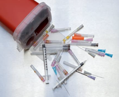 Sharps and red sharps container