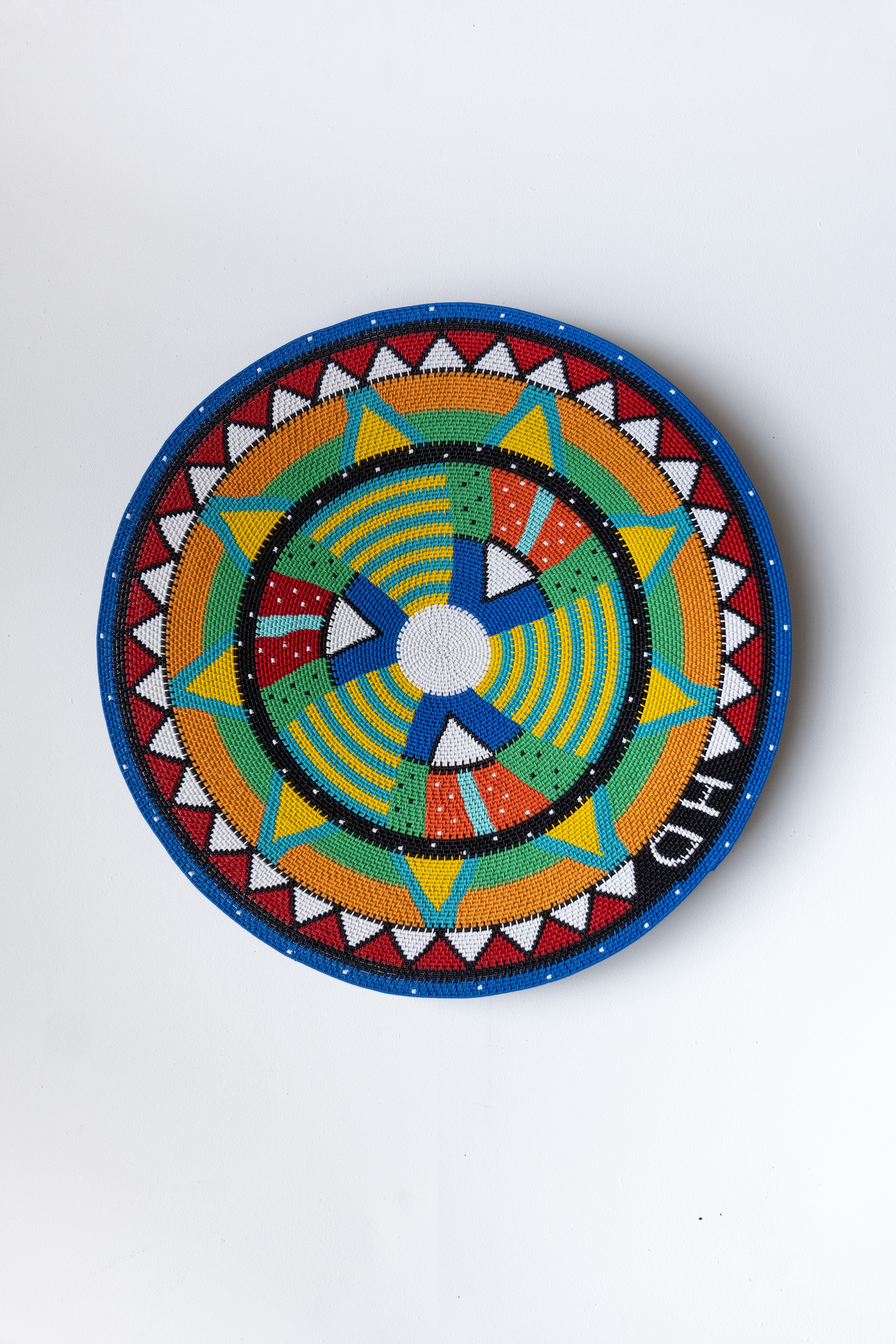Woven with multicoloured geometric pattern, 65cm diameter, 2025.