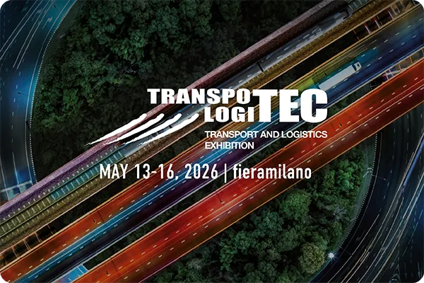 Veduta aerea di un’infrastruttura stradale multilivello illuminata di notte con il testo “Transpotec Logitec – Transport and Logistics Exhibition, May 13–16, 2026, fieramilano”
