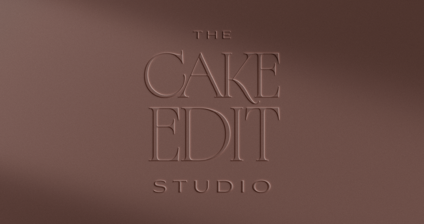 Embossed text reading 'The Cake Edit Studio' on a smooth chocolate brown surface.