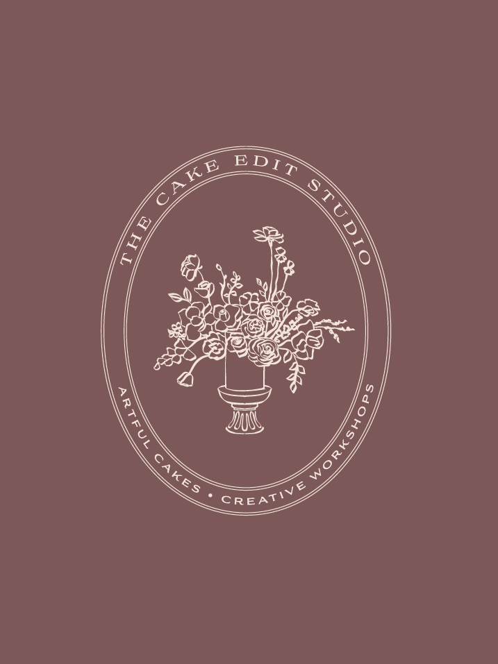 Logo featuring an elegant cake with floral decoration in a pedestal bowl, encircled by text that reads 'The Cake Edit Studio' and 'Artful Cakes • Creative Workshops' on a muted mauve background.
