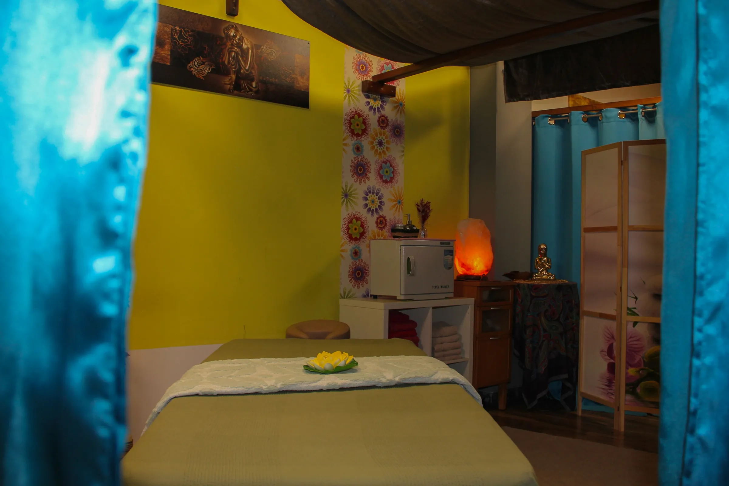 Massageliege vor gelber Wand in einer ruhigen Behandlungskabine bei BIU Thai Massage Kelheim