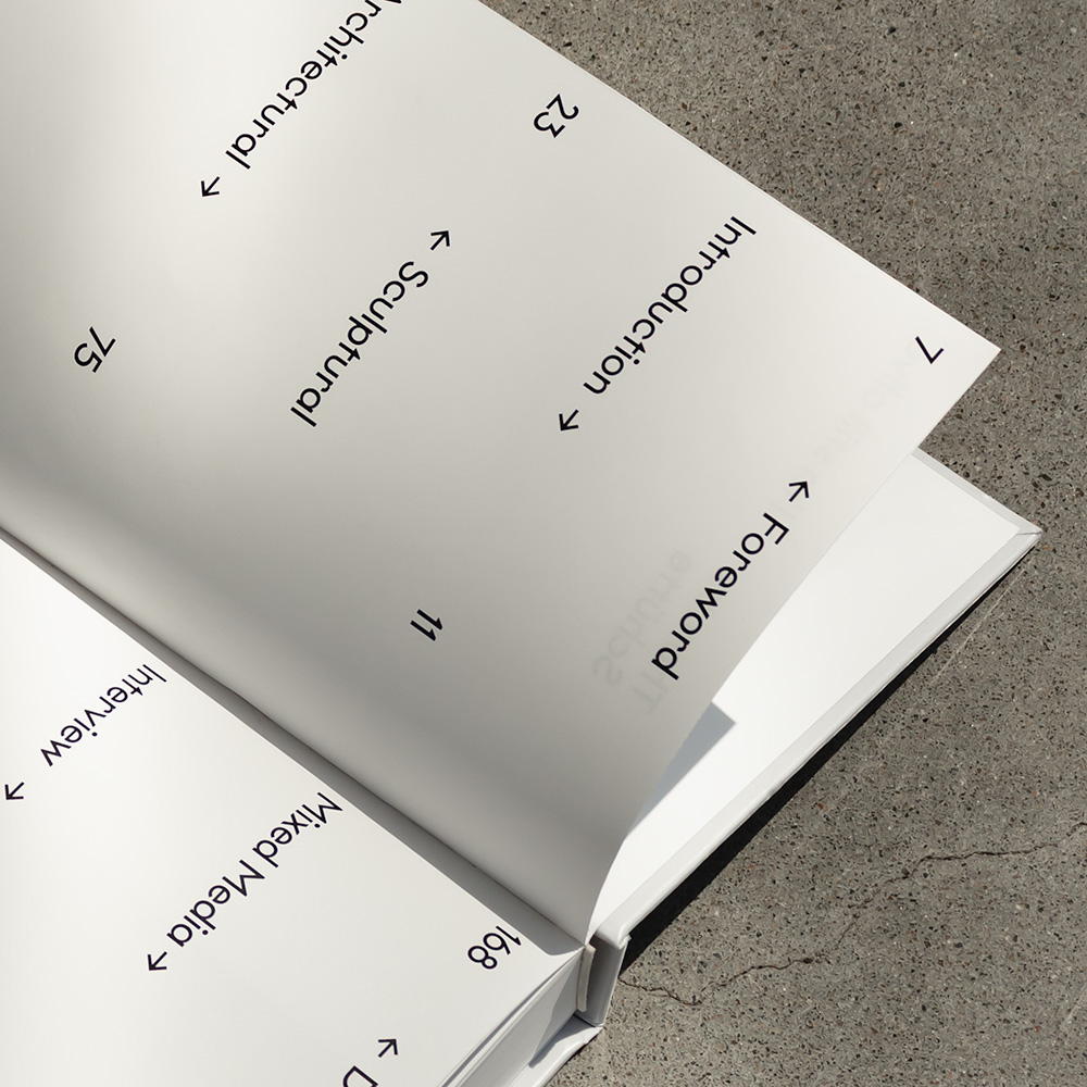 Closeup of a book’s table of contents. Each chapter name has an arrow next to it pointing horizontally towards the according page number, with the name and number positions alternating from one line to the next.