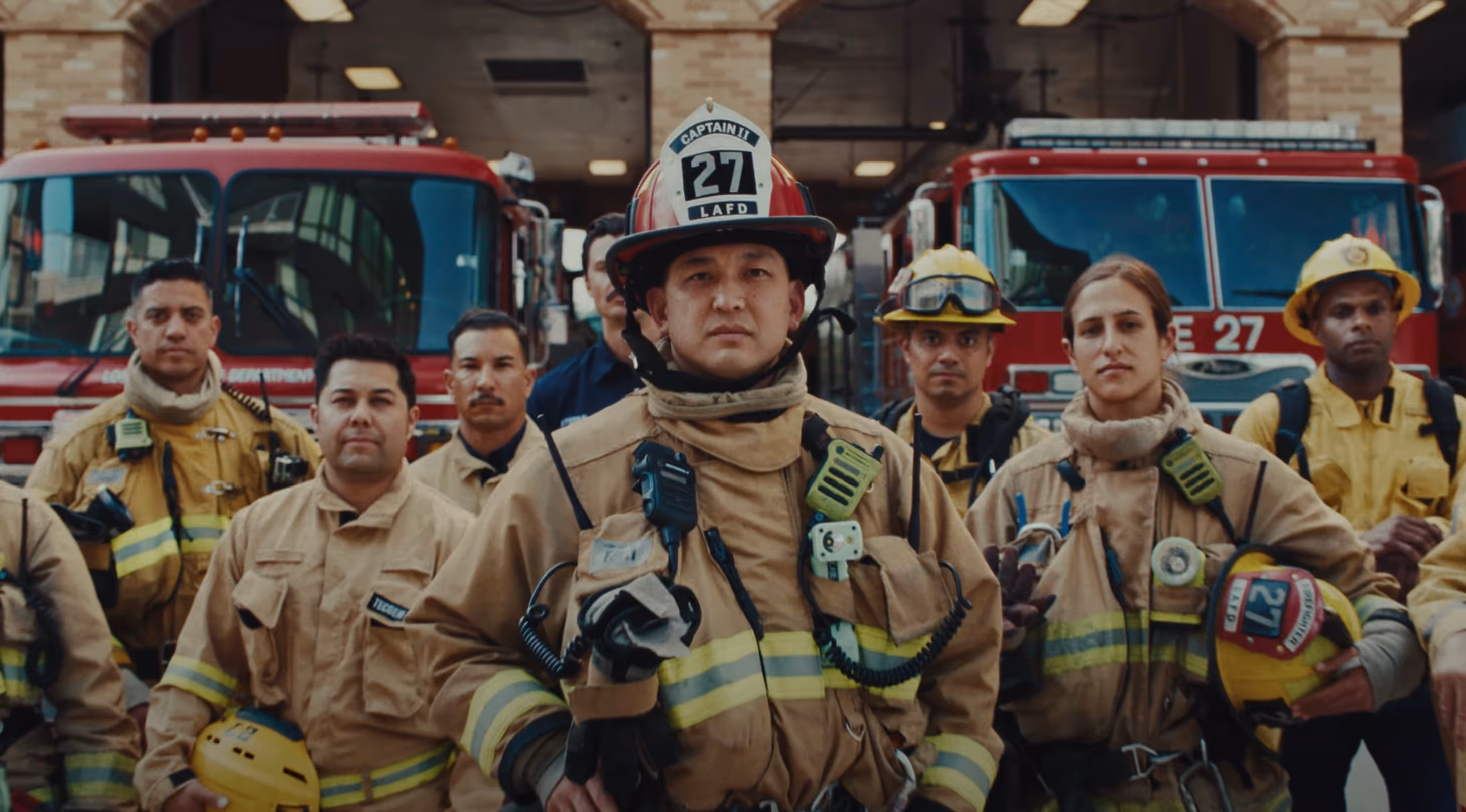 A group of diverse Los Angeles firefighters wearing turnouts.