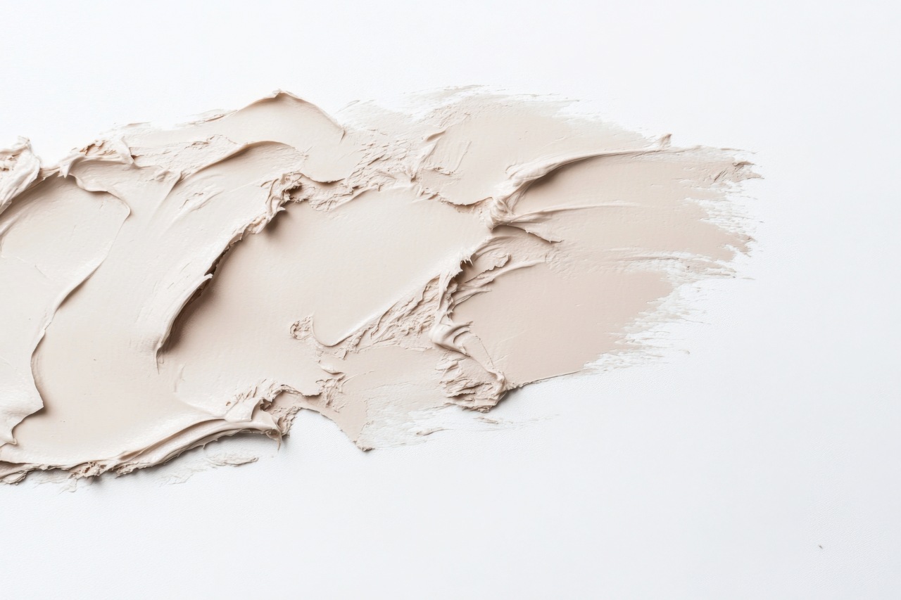Smear of off-white putty spread across a white surface