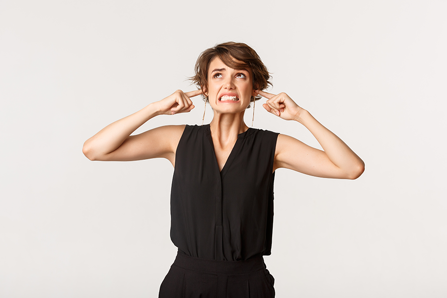 Disturbed young woman looking up with annoyed face