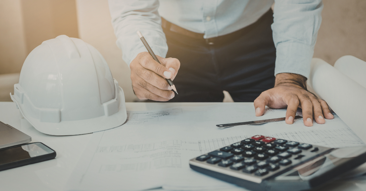 Construction blueprints and calculator used to prepare proper invoices for BC and Alberta projects.